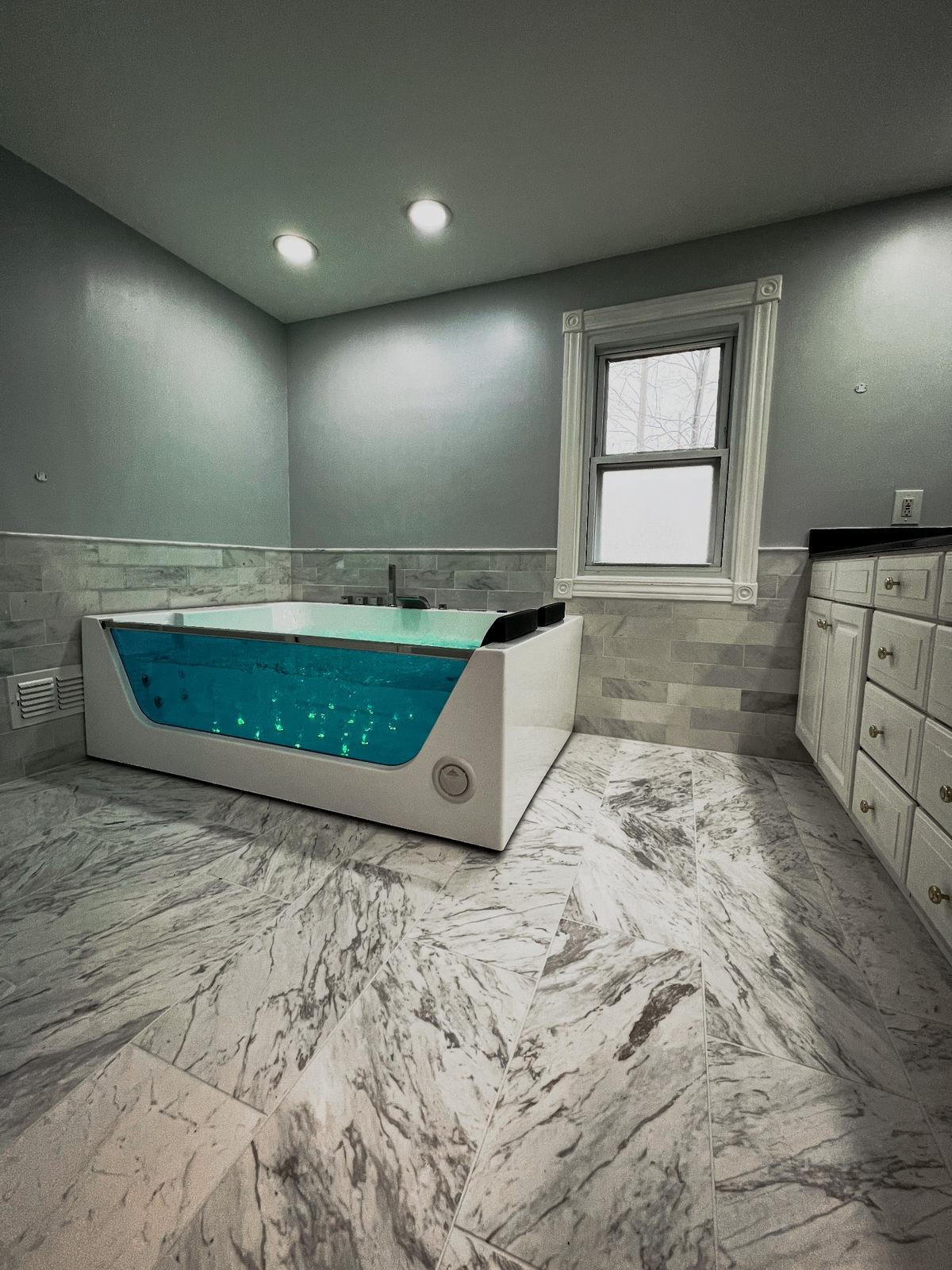 Custom Modern bathroom remodel with marble flooring Modern bathroom remodel with marble flooring and illuminated jetted tub – Ferndale, MI