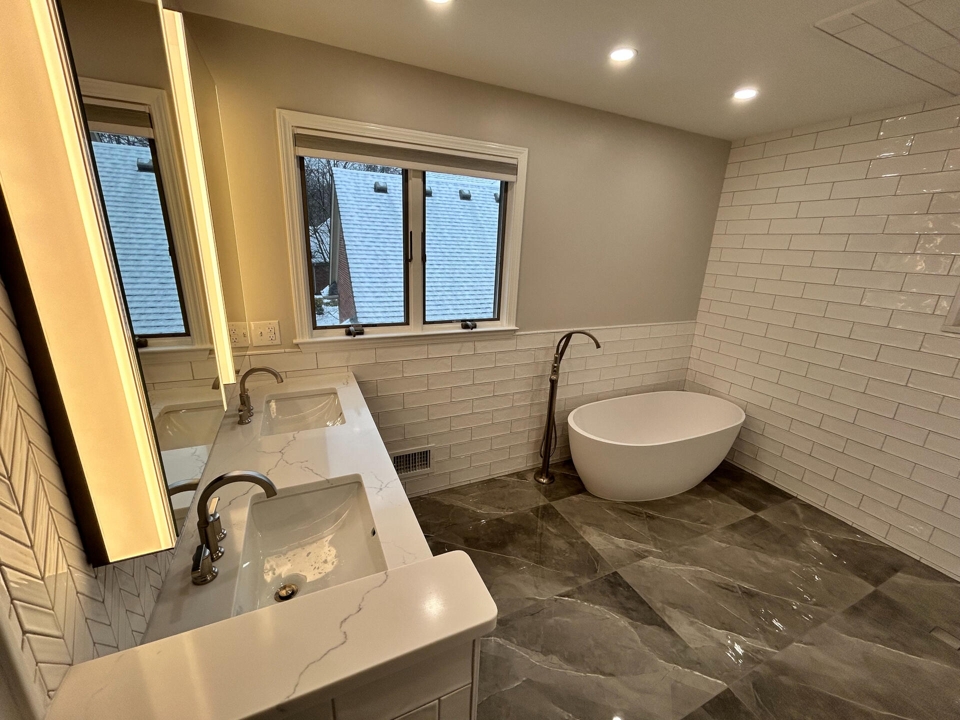 Luxury Bathroom with Skylight and Marble-Inspired Shower – Birmingham, MI Elegant bathroom renovation with freestanding tub, skylight, and custom walk-in shower with marble-look tile – upscale remodel in Birmingham, Michigan