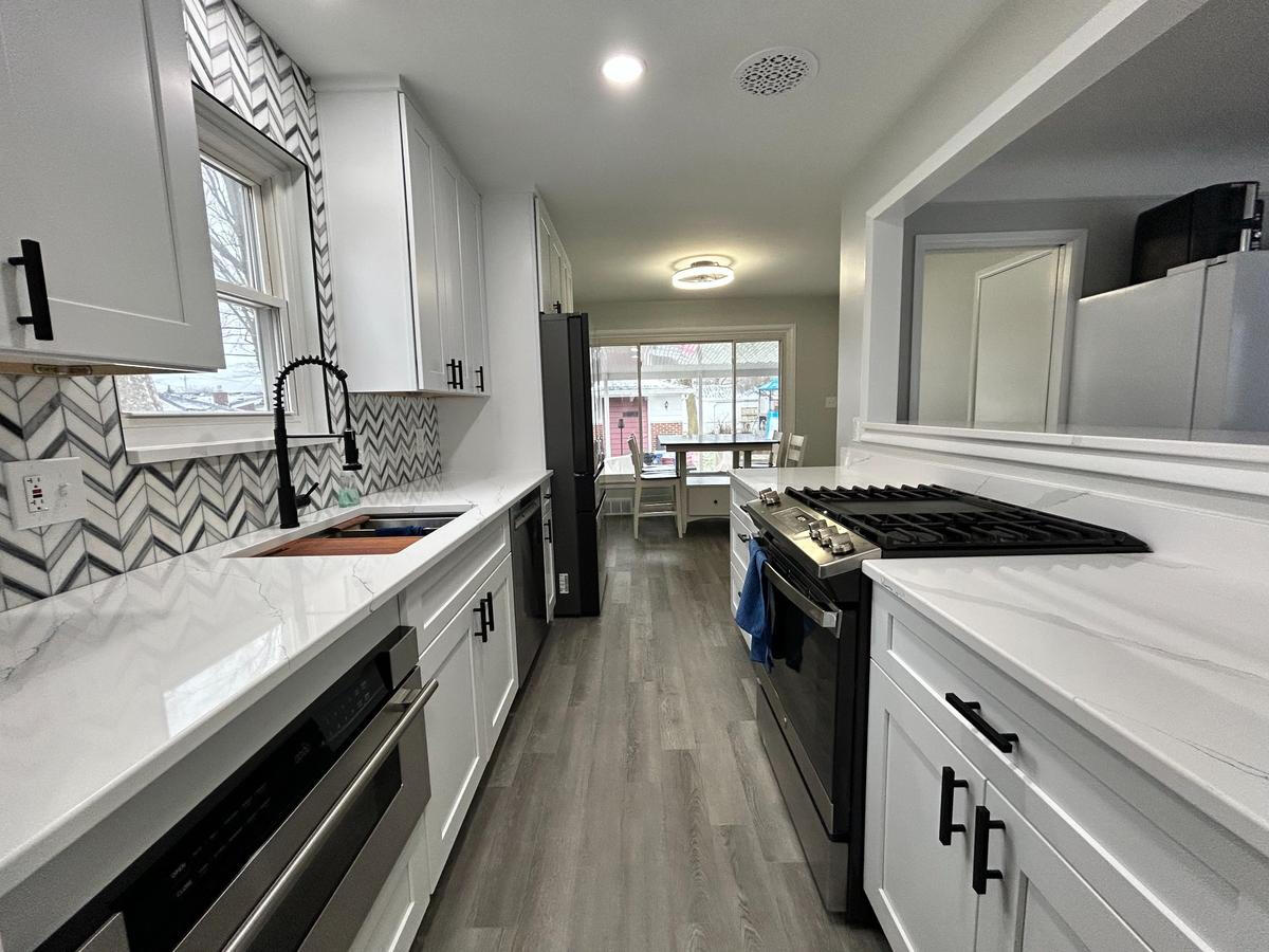 Modern White Galley Kitchen Remodel – Michigan White modern galley kitchen with quartz countertops and stainless steel appliances – Royal Oak, Michigan