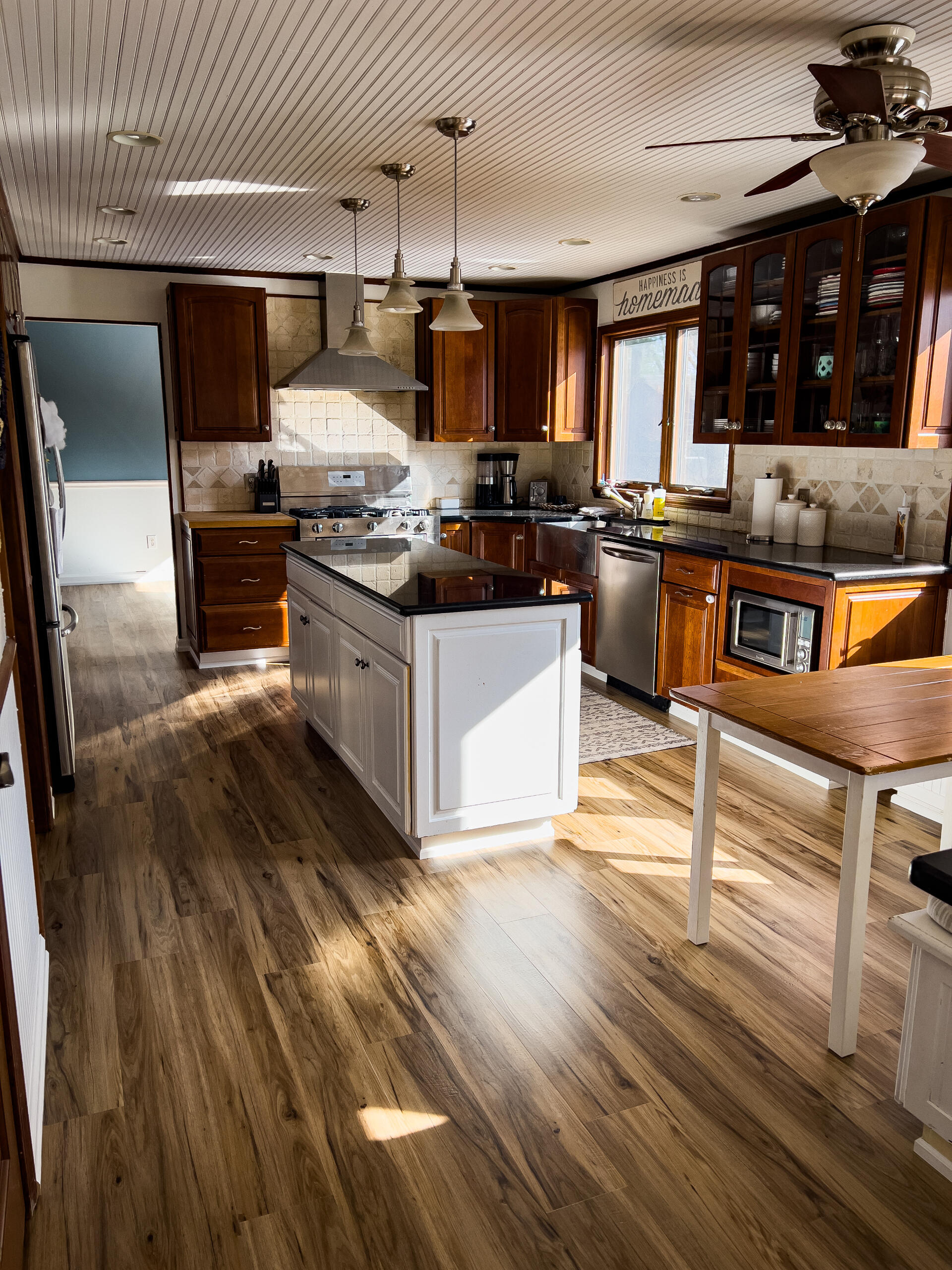 Brighton Kitchen Renovation with Wood Cabinets and Island Warm-toned kitchen remodel with wood cabinetry, center island, and luxury vinyl plank flooring – Ferndale, Michigan